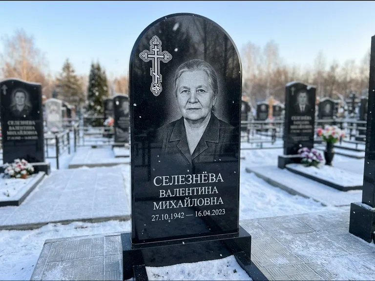 Памятник из чёрного гранита — массивная стела с крестом в лучах с крестом в лучах, работа «Одинцова» в Оренбурге